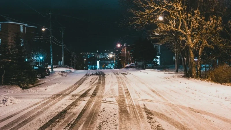 Snowy street at night in Buffalo during winter