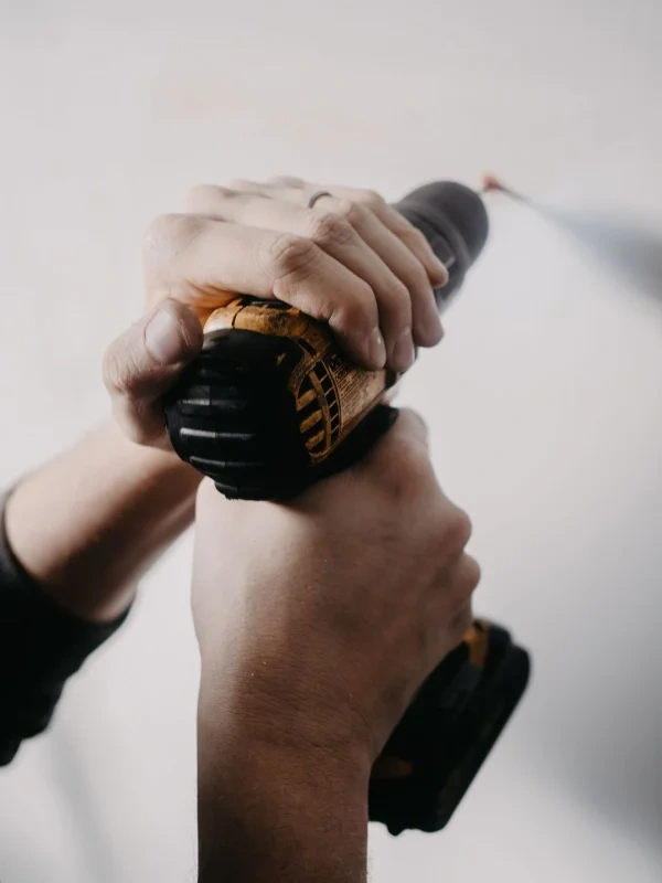 Close-up of a drill sealing a rodent entry point on a Buffalo home
