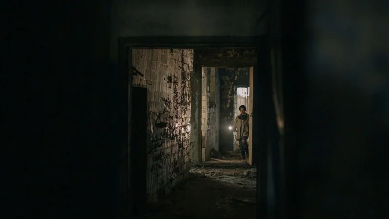 Inspector checking a dark interior with a flashlight